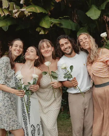 Graduates together with white roses after the closing ceremony