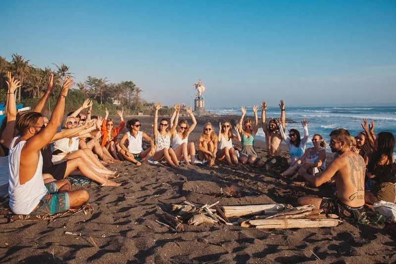 A beach bonfire circle at sunset