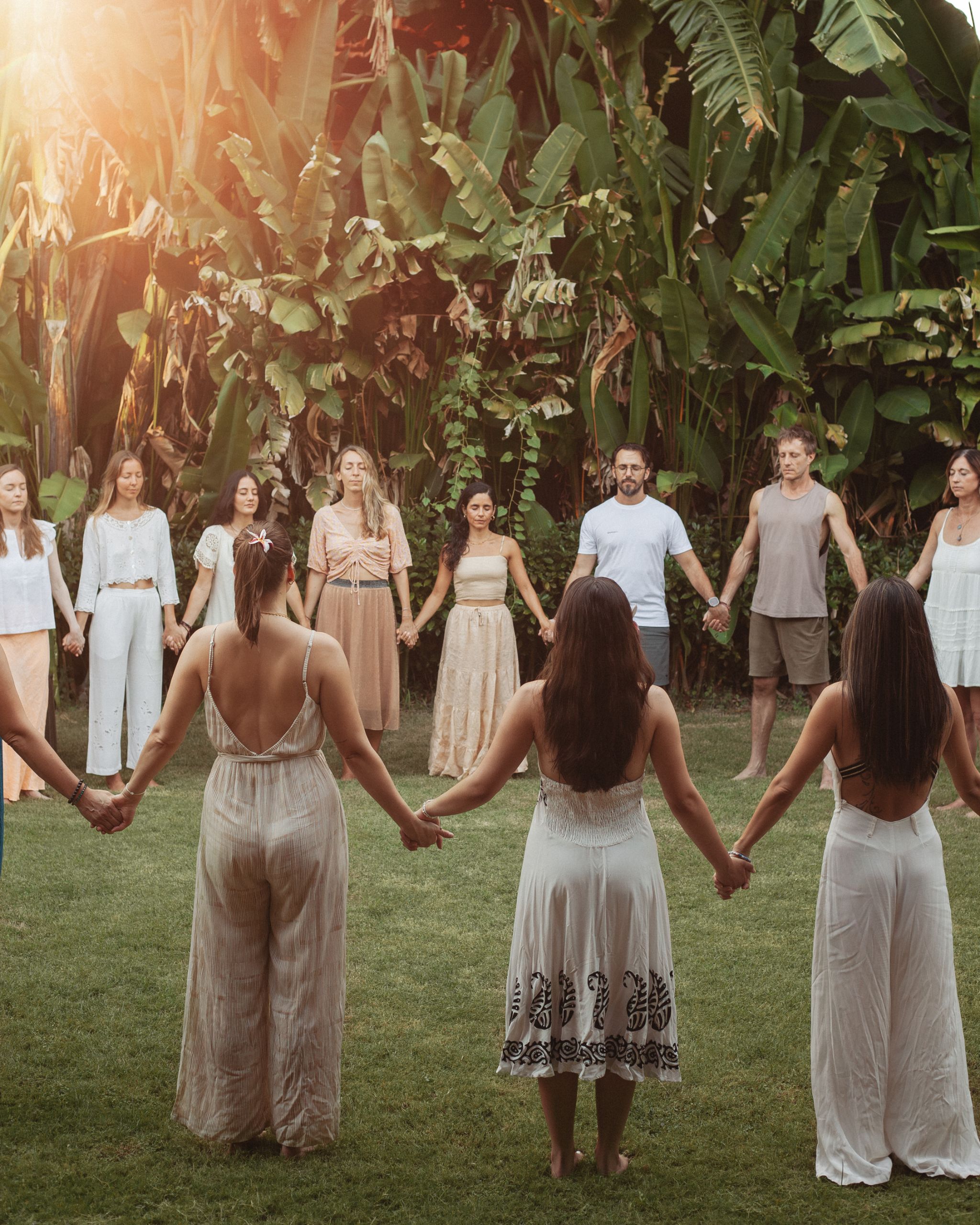 Hands joined at the closing circle at sunset