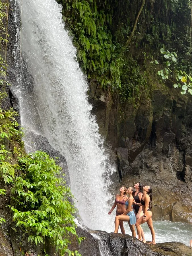 Friends at a jungle waterfall