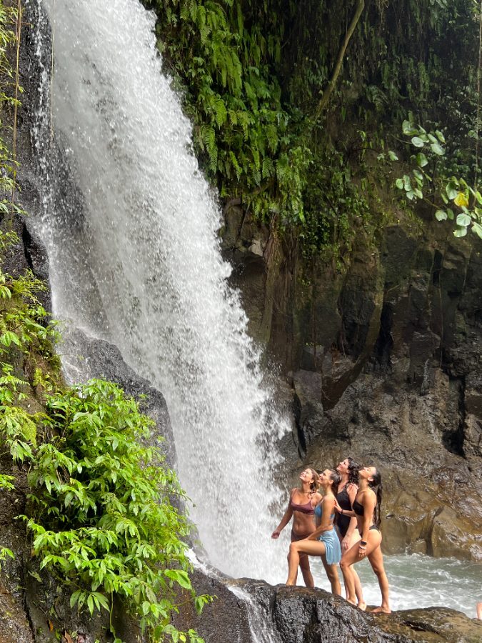 Friends at a jungle waterfall