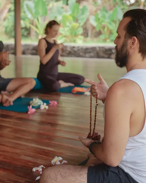 Students in seated mala practice in the shala