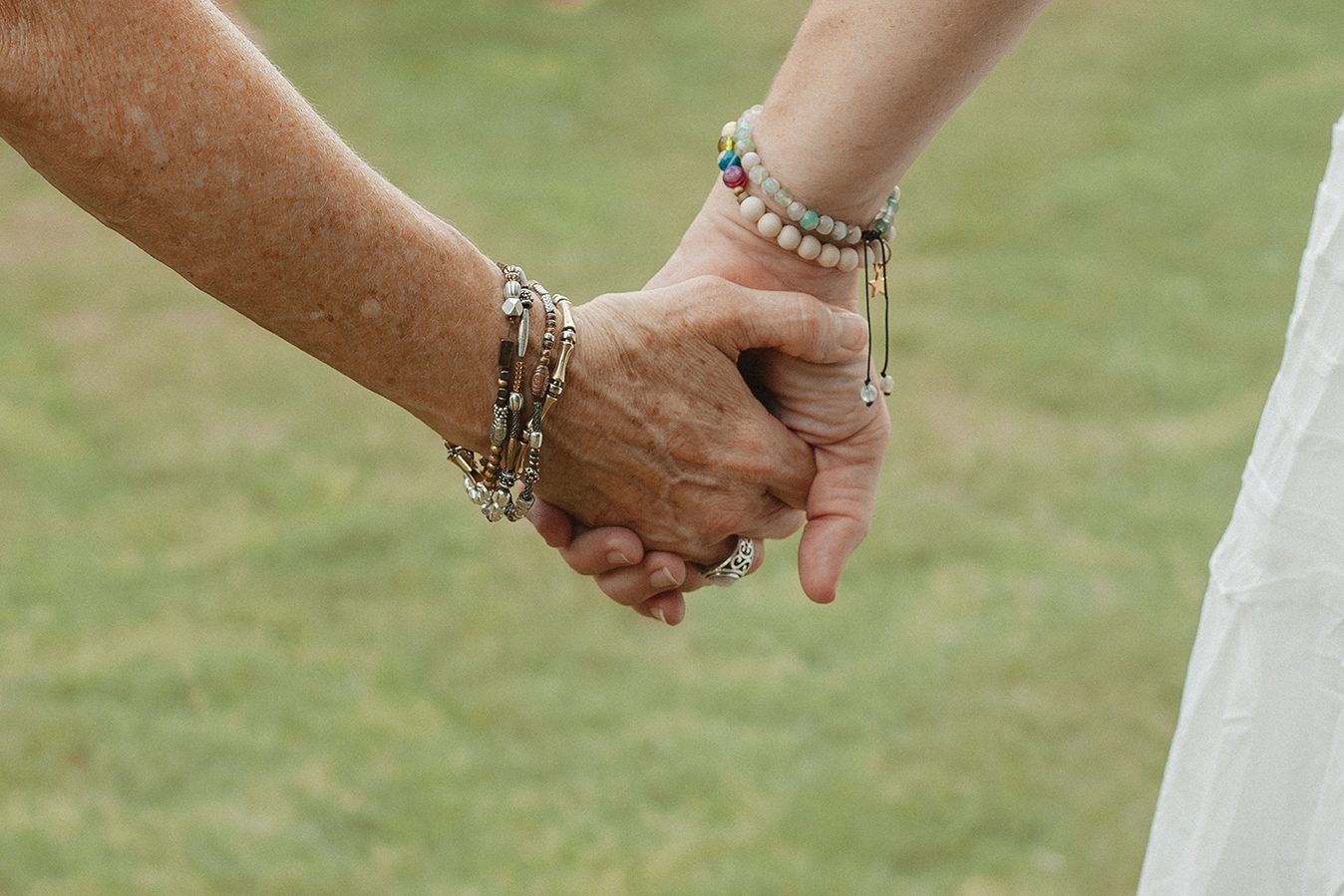 Two people holding hands, close up