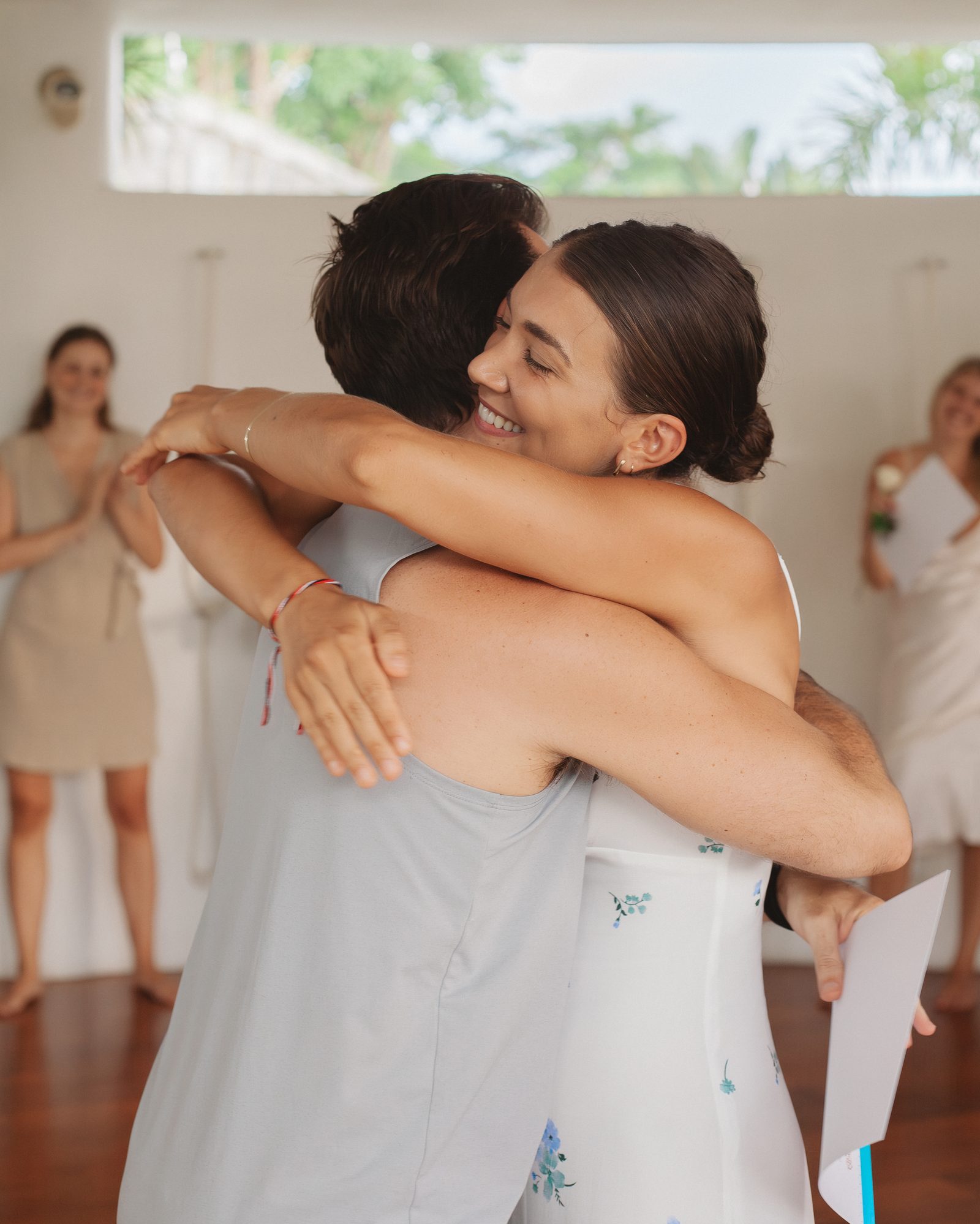 A graduate embraces her teacher at the Samasti Yoga graduation ceremony in Bali