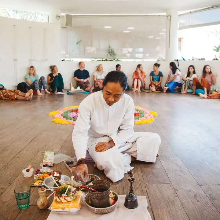 A Balinese priest leading a blessing ceremony in the shala