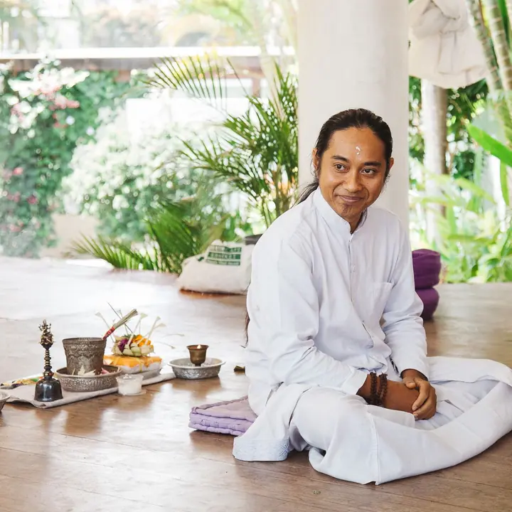 The priest seated in the shala before a ceremony