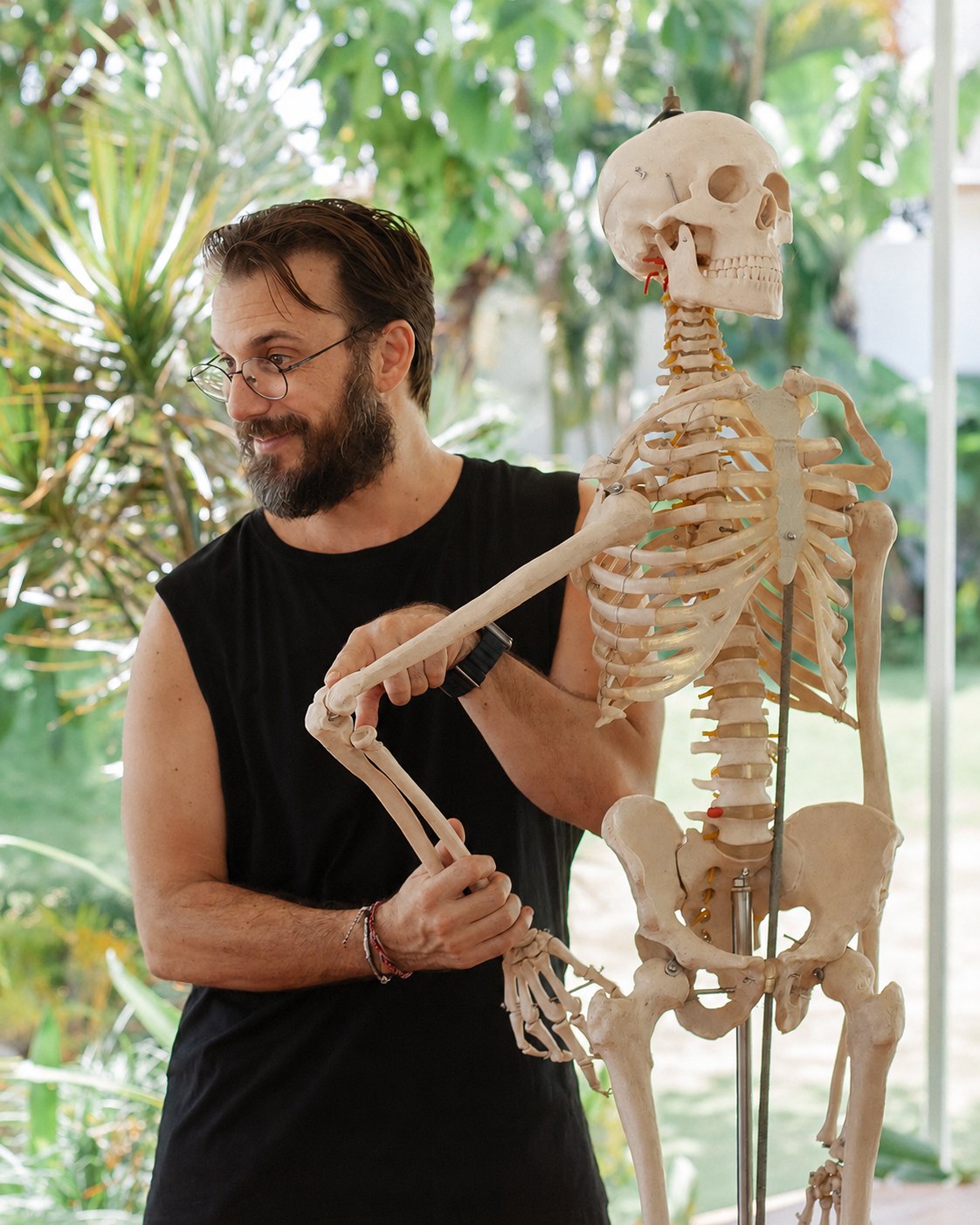 Sean demonstrating the elbow joint on a full size skeleton model during an anatomy class